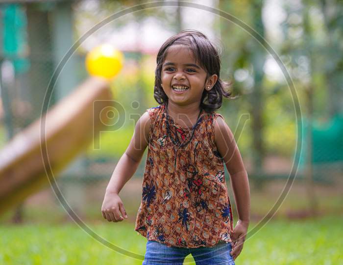 Indian little girl smiling with teeth