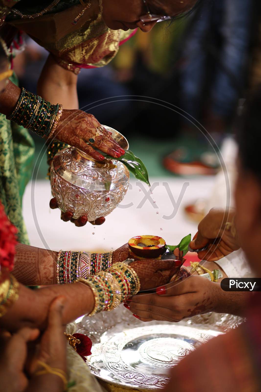 Indian bride getting sacred water