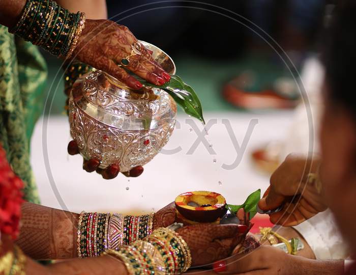 Indian bride getting sacred water