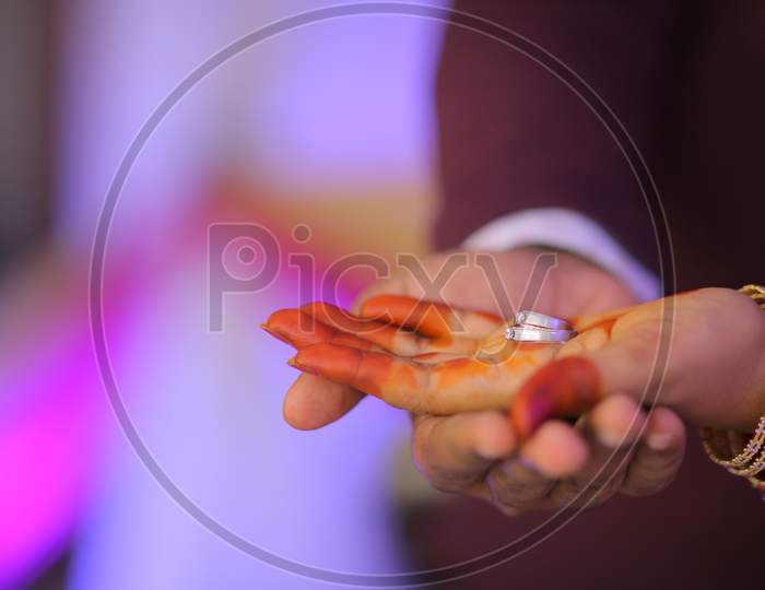 Indian Bride holding engagement ring in hand