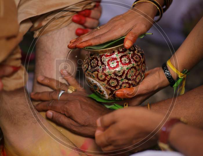 Indian bride groom legs washing during Wedding ceremony