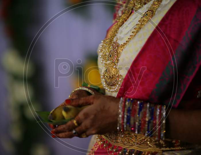 Indian Bride holding banana and betel leaves