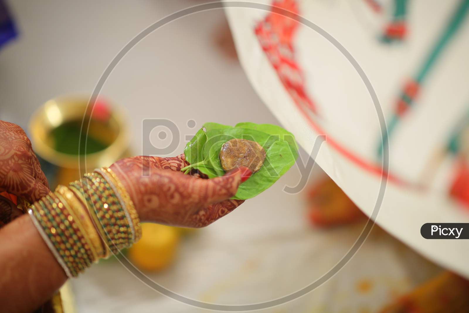 Indian bride holding Cumin and jaggery