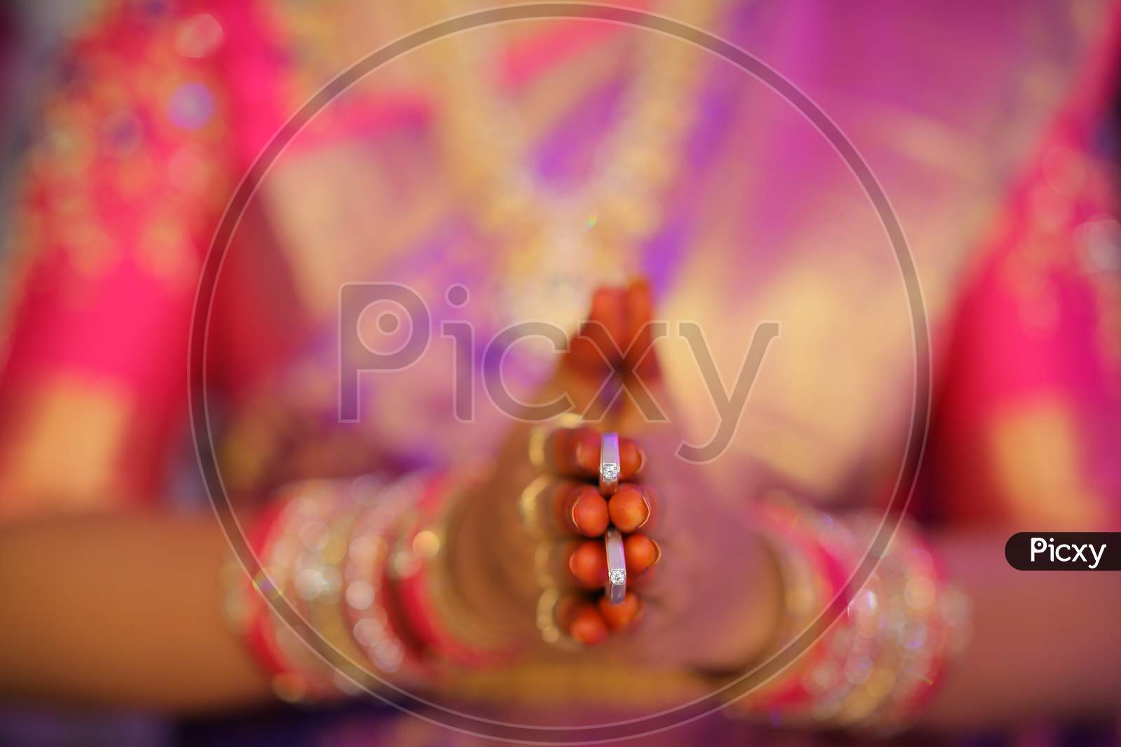 South Indian bride holding diamond rings in her hand
