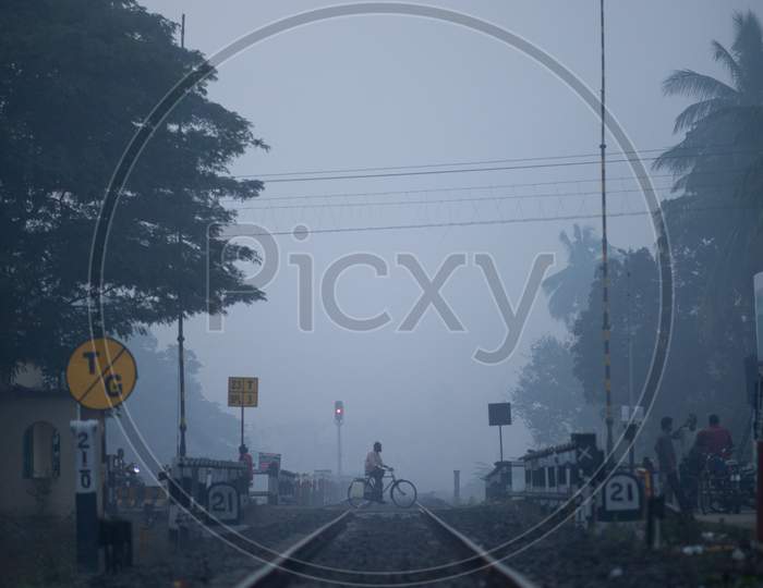 People Crossing The Railway Track At an Railway Gate  On an Winter Morning