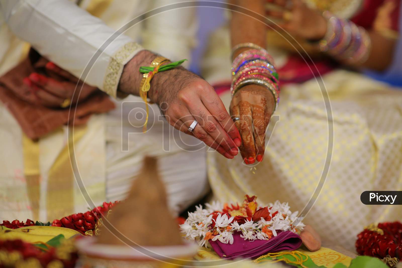 Indian Bride and Groom offering during Puja