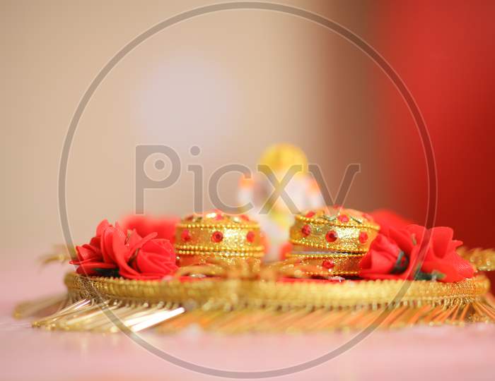 Indian wedding rings in holder during puja