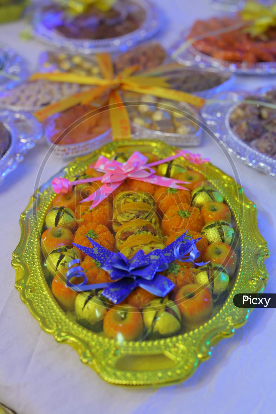 Fruits and sweets served in packages during Engagement ceremony
