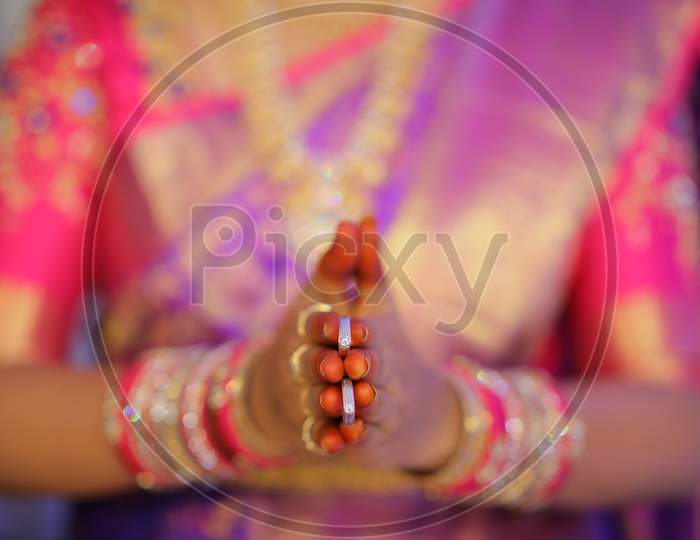 South Indian Bride holding engagement rings during wedding ceremony