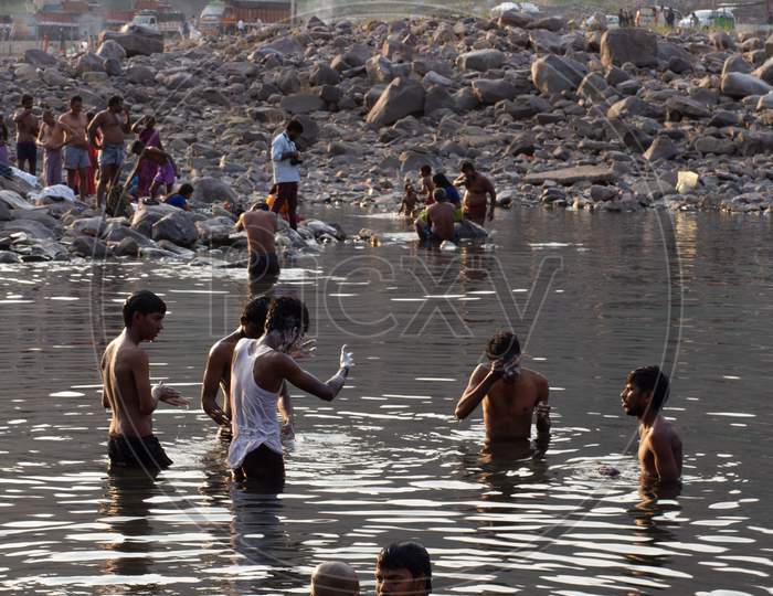 Indian tourists bathing in the river