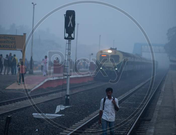 A Man Walking on Railway track  On an Winter Morning