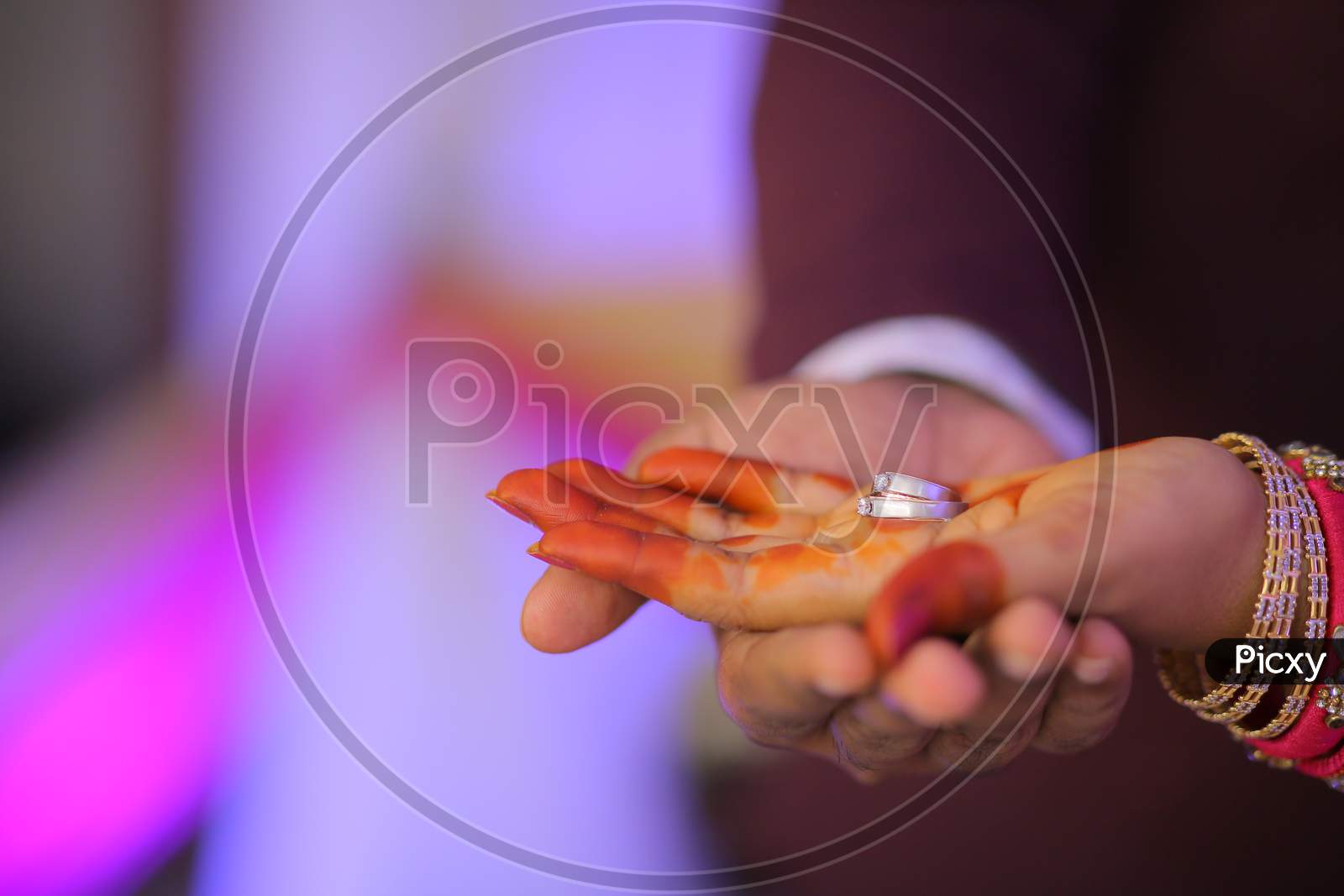 Indian Bride holding engagement ring in hand