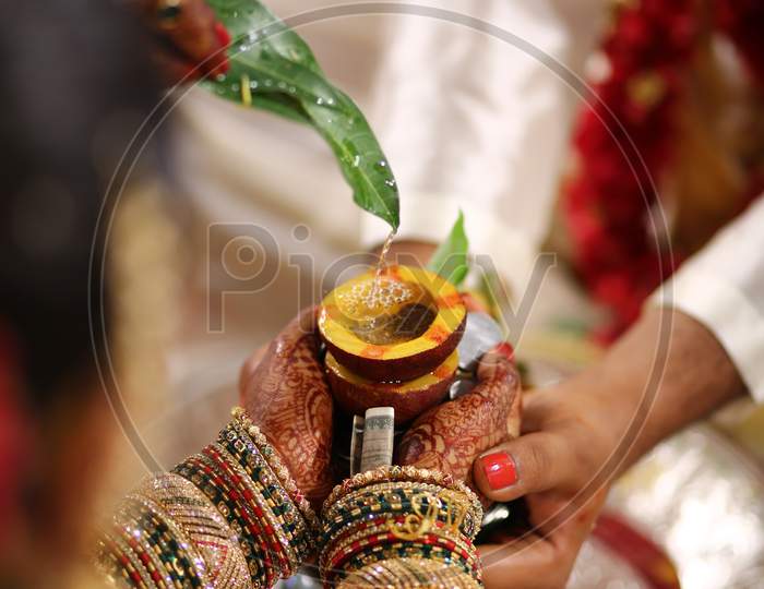 Indian Bride holding sacred dried coconut