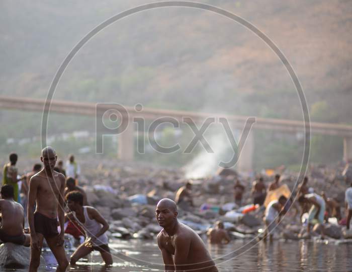 Indian devotees bathing in the river