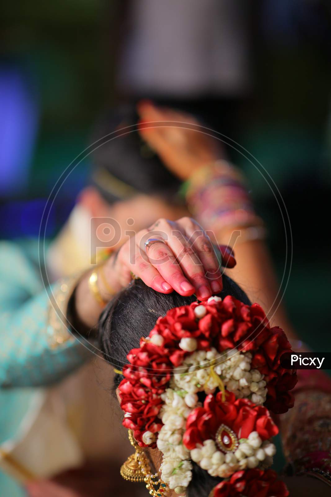Indian Bride Groom putting cumin and jaggery on bride's head