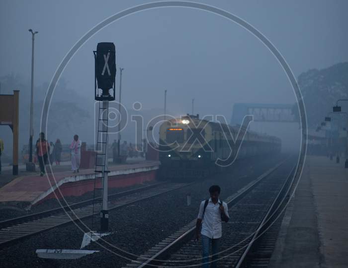 A Man Walking on Railway track  On an Winter Morning