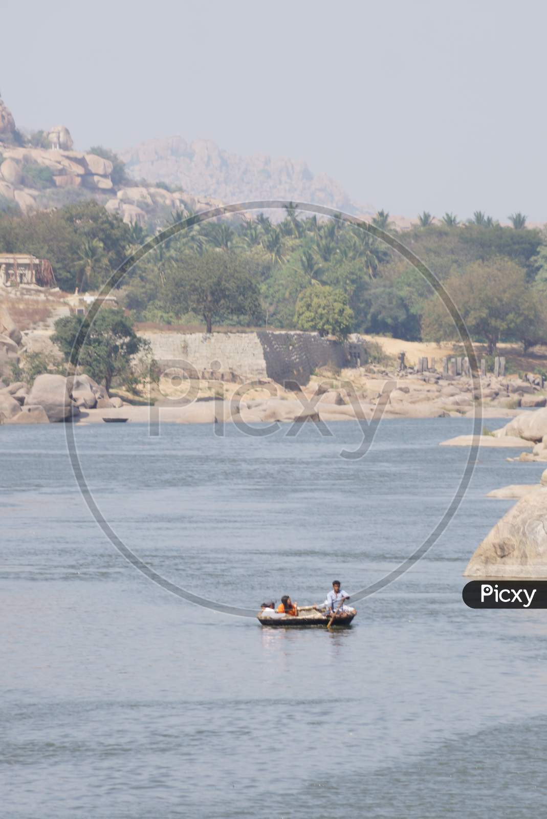View of tourist traveling in coracle boat in Hampi
