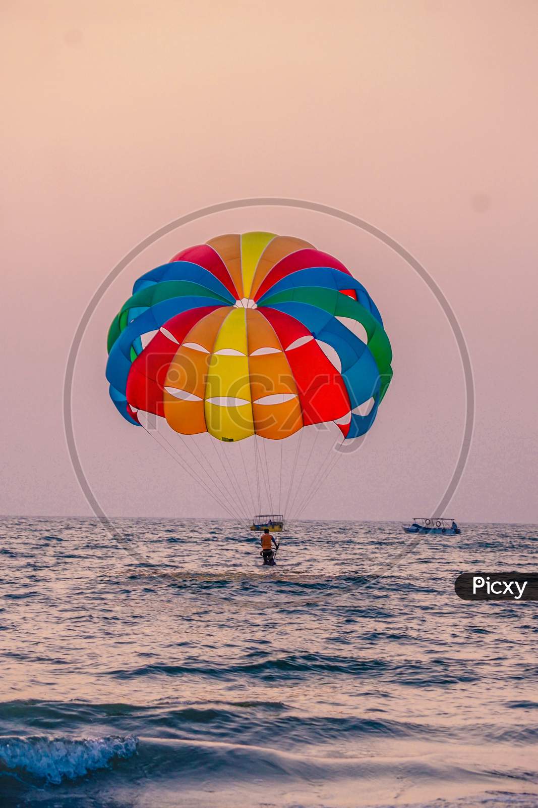 View of Indian Tourist Paragliding in the beach