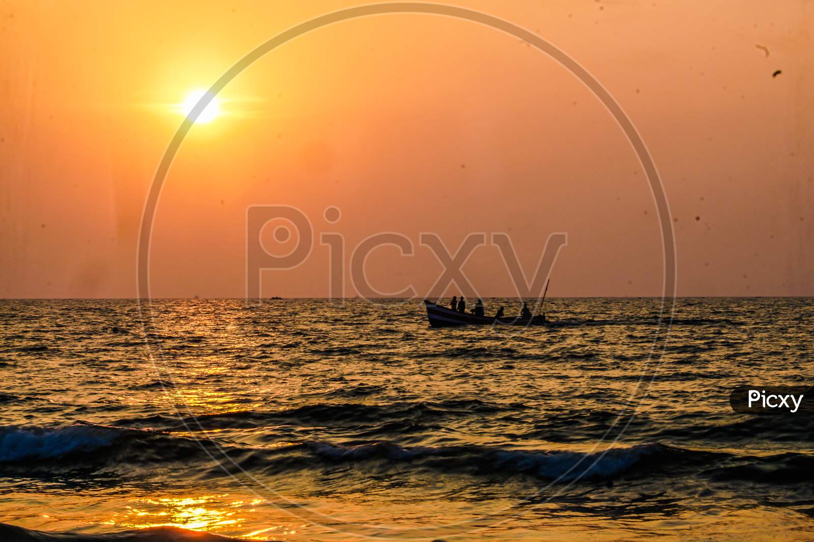Local fishermen during sunset in Goa