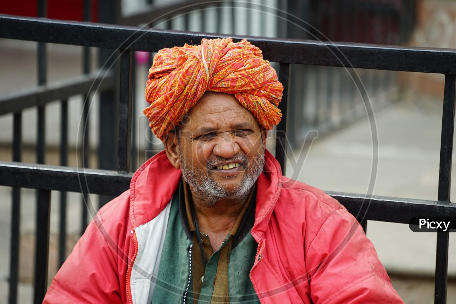 Indian elderly man smiling wearing turban