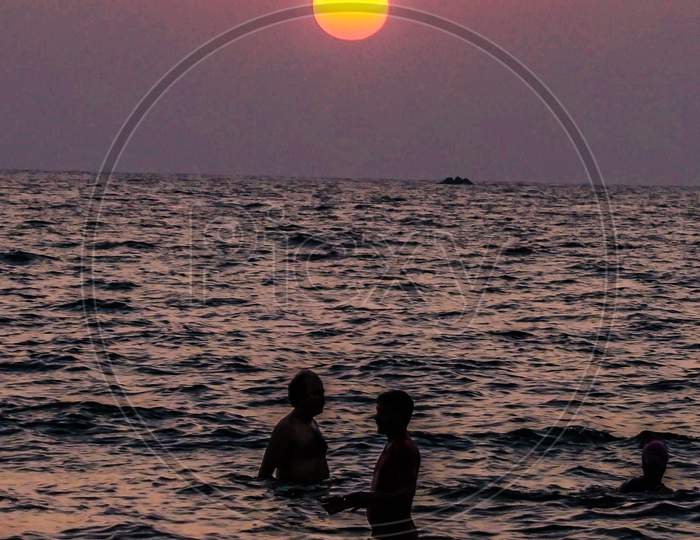 Silhouette of Indian tourists in the beach during sunset