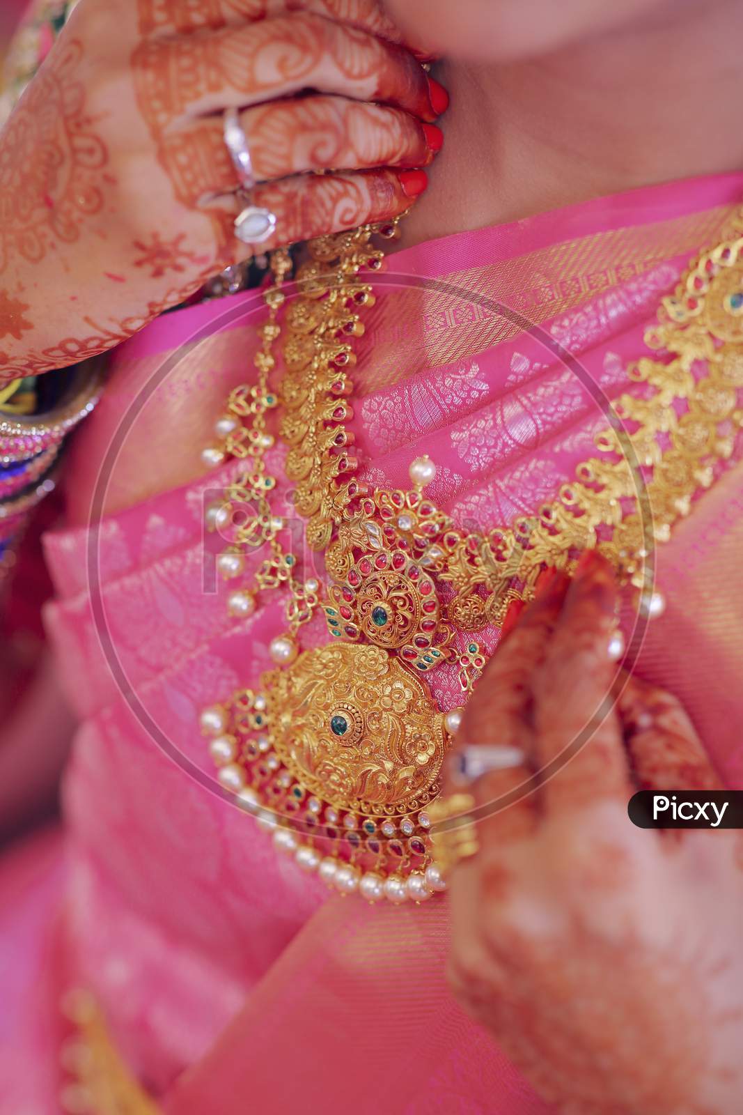 Indian Bride Wearing Elegant Gold Jewelery At an Indian Wedding