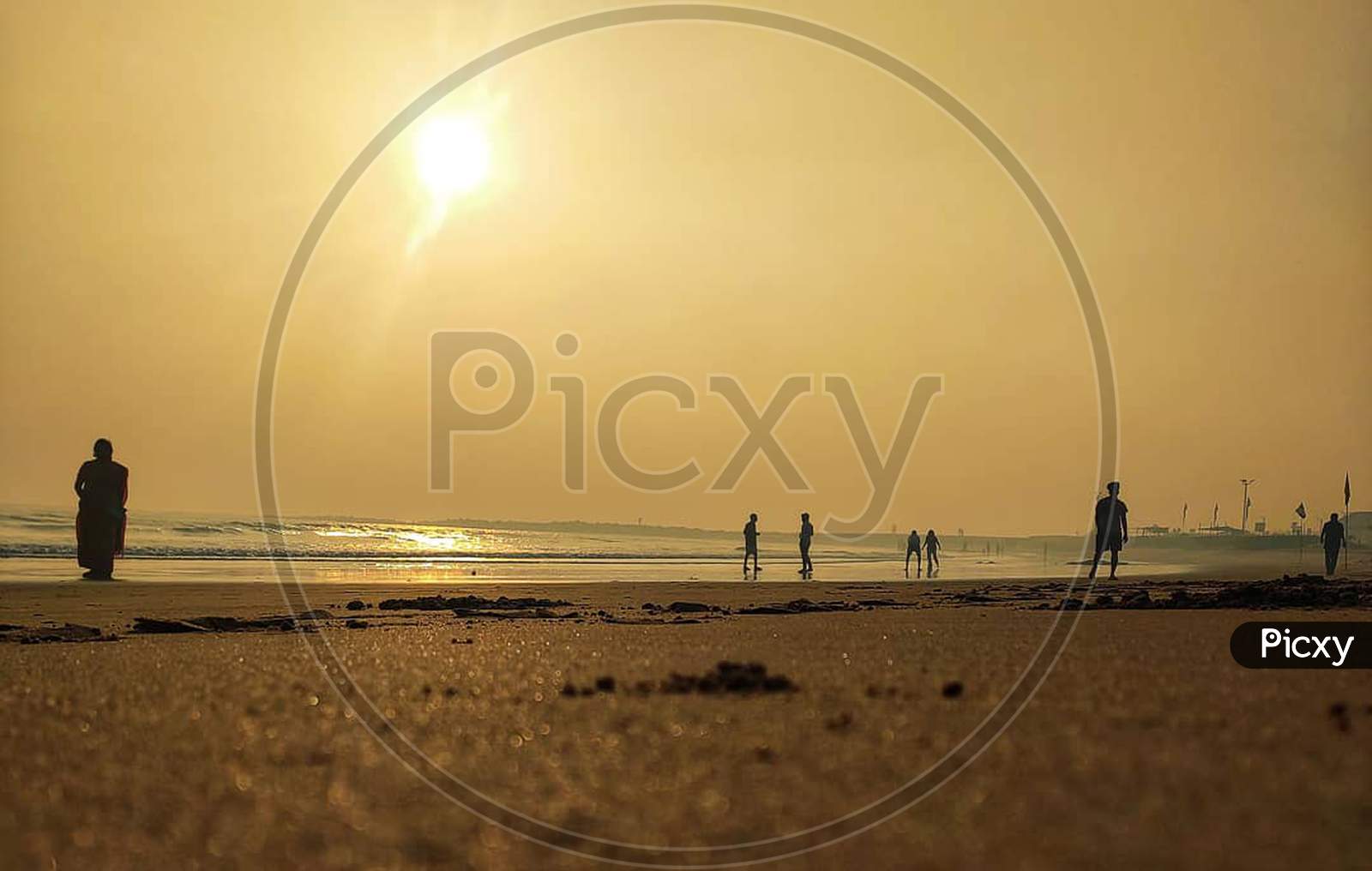 Silhouette Of People In A Beach