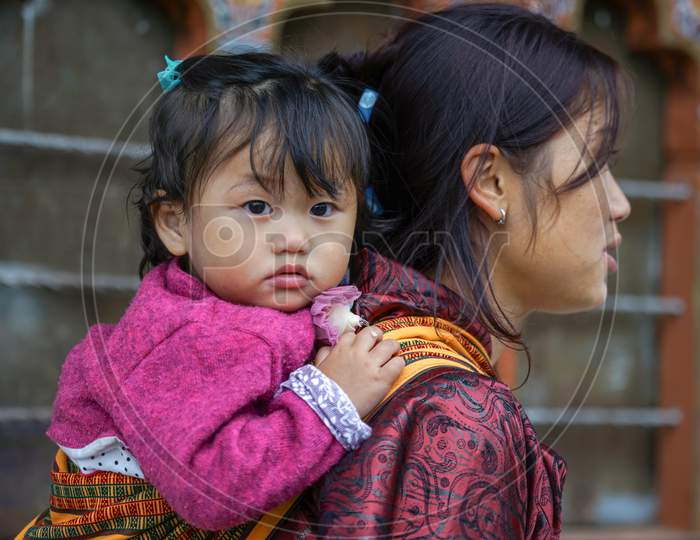 A Nepalese Mother carrying her child