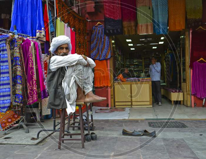 A Rajasthani man sitting outside a stall
