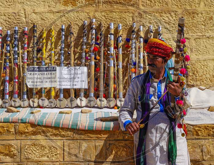 Rajasthani man selling traditional violins