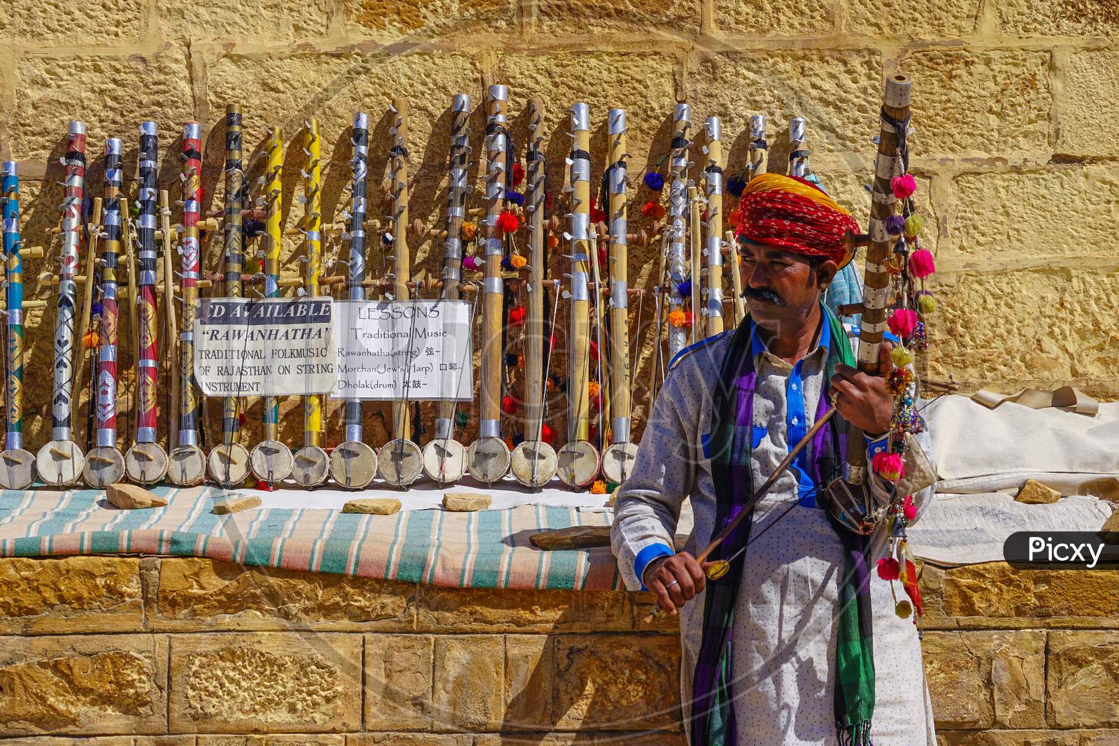 Rajasthani man selling traditional violins