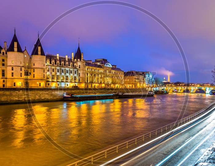 The Conciergerie And The Seine River In Paris - France