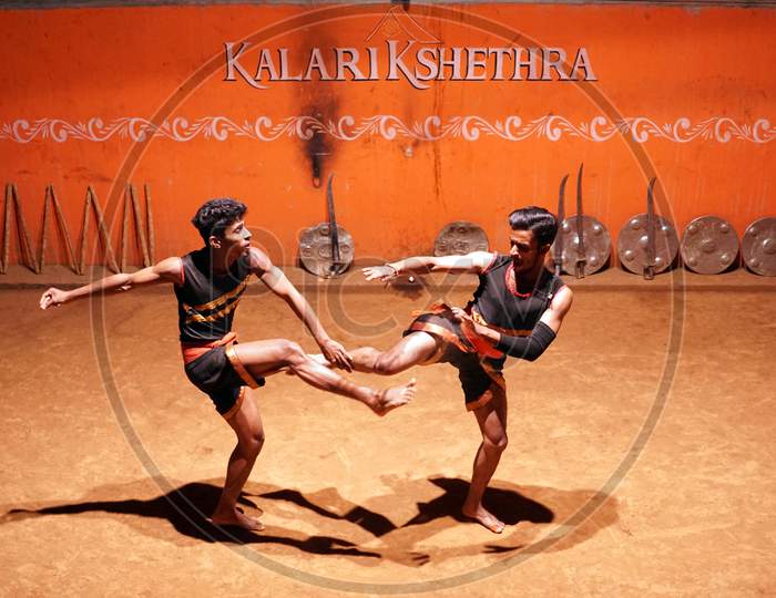 Indian men performing Kalaripayattu in the ring