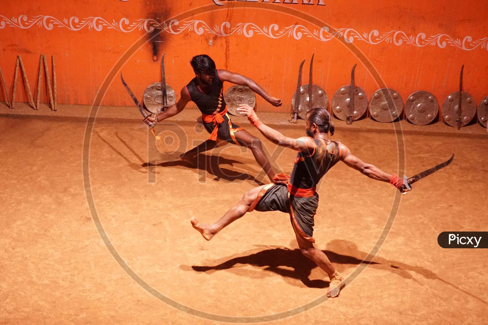 Indian acrobats fighting with swords