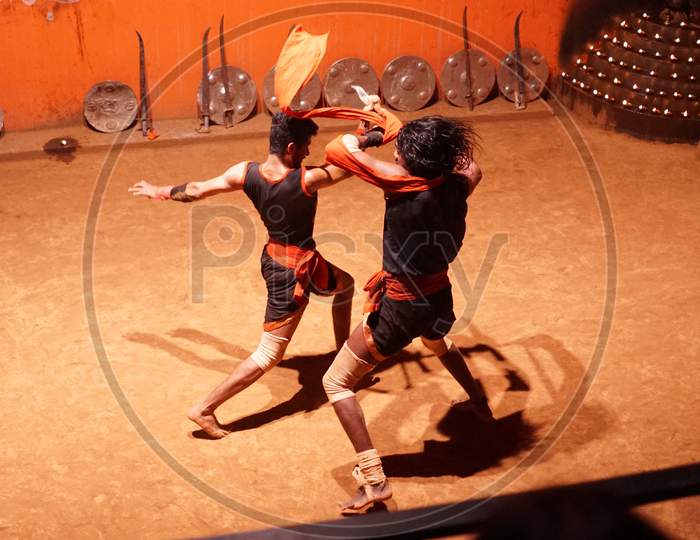 Indian men performing sword fight in the arena