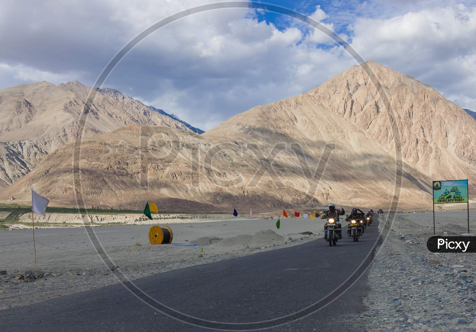 a group of Royal Enfield Bike riders passing through the Magnetic Hill