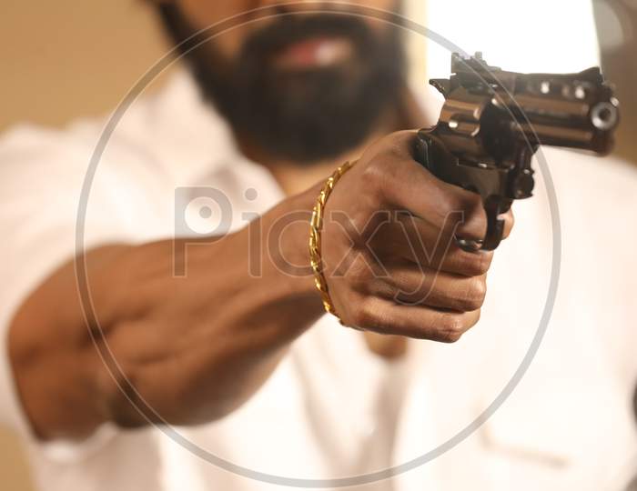 Man Aiming Pistol or Gun Or Revolver In Hand Closeup