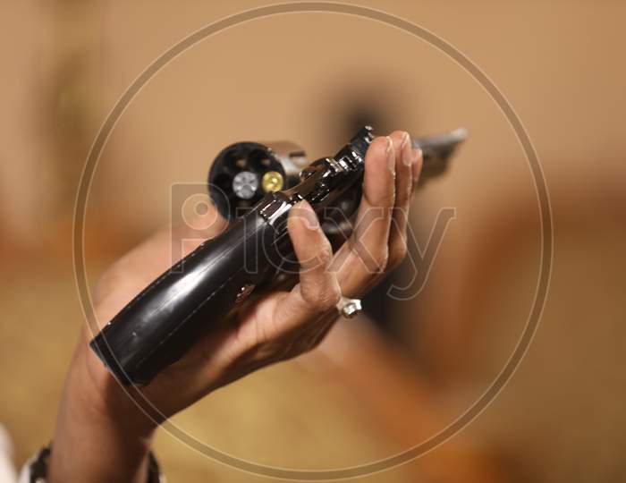 Indian Young Woman Holding Gun or Pistol Or Revolver In hand Closeup