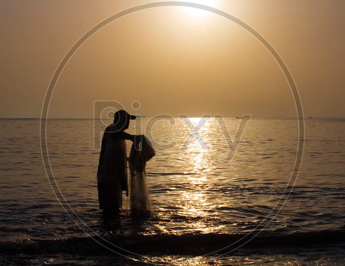 Fisherman Preparing his Fishing Net