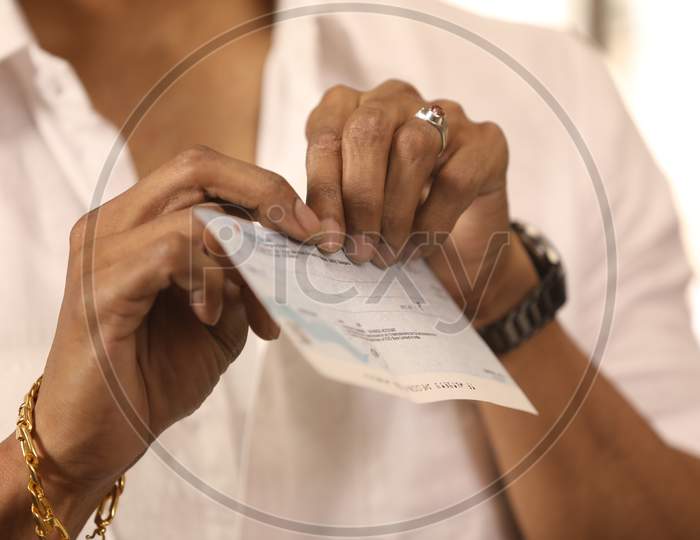 Man Tearing Cheque or Paper Or Document Hands Closeup