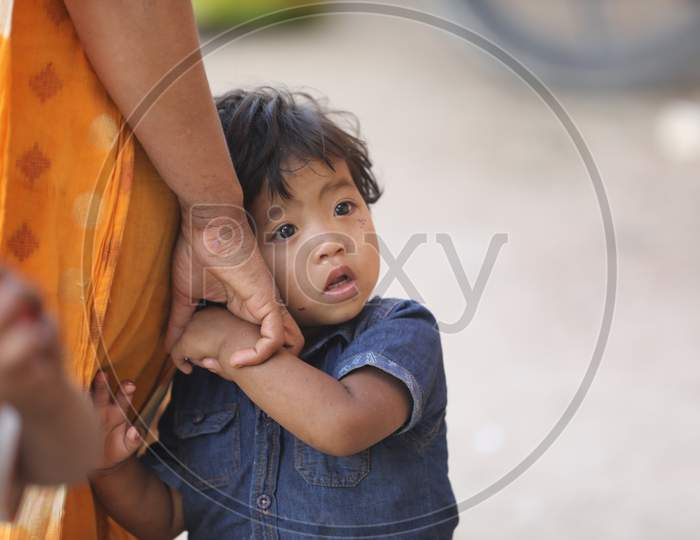 An Indian Mother Holding Hands Of a Child