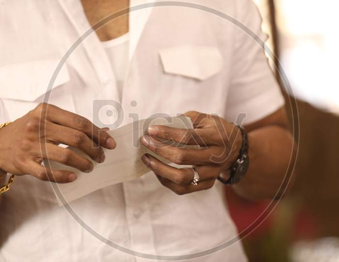 Man Tearing Cheque or Paper Or Document Hands Closeup