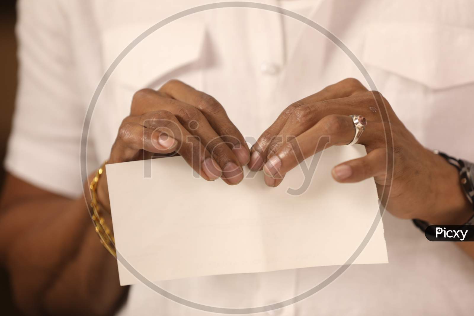 A Man Tearing Paper Hands Closeup