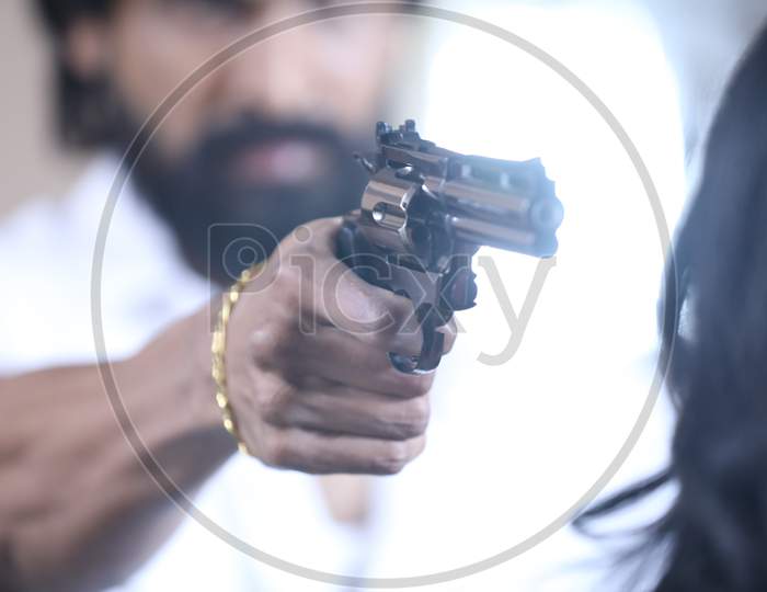 Man Aiming Pistol or Gun Or Revolver In Hand Closeup