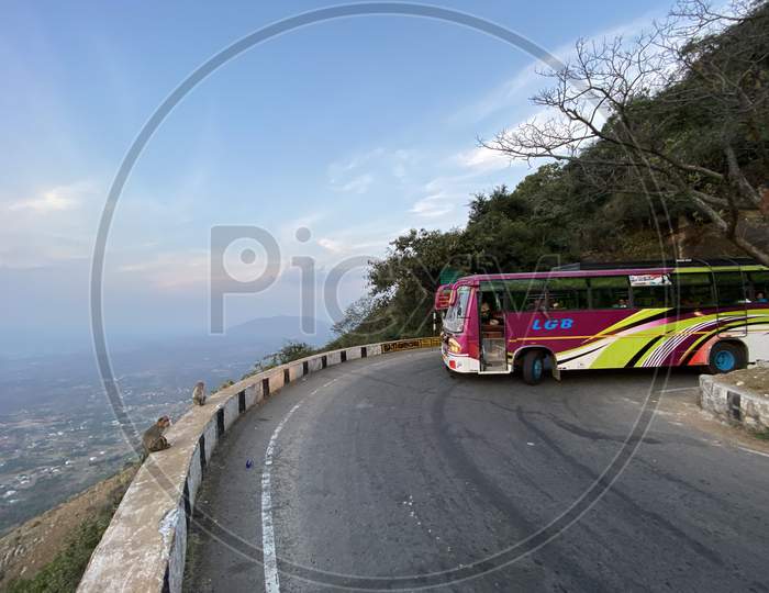 A Travel bus taking a turn on the  Yelagiri ghat road Hairpin curve