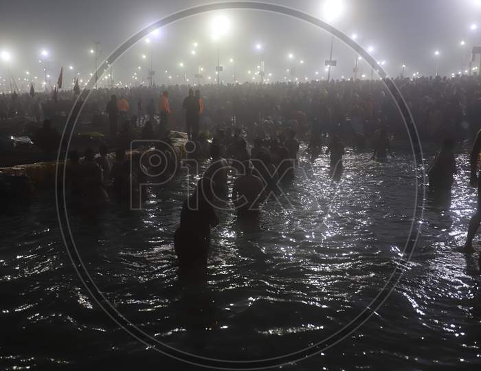 Crowd Of Hindu Devotees Taking Holy Bath  At Triveni Sangam River In Prayagraj  During Magh Mela 2020