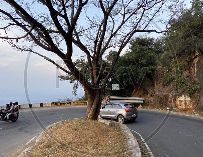 A Car taking a turn on the ghat road