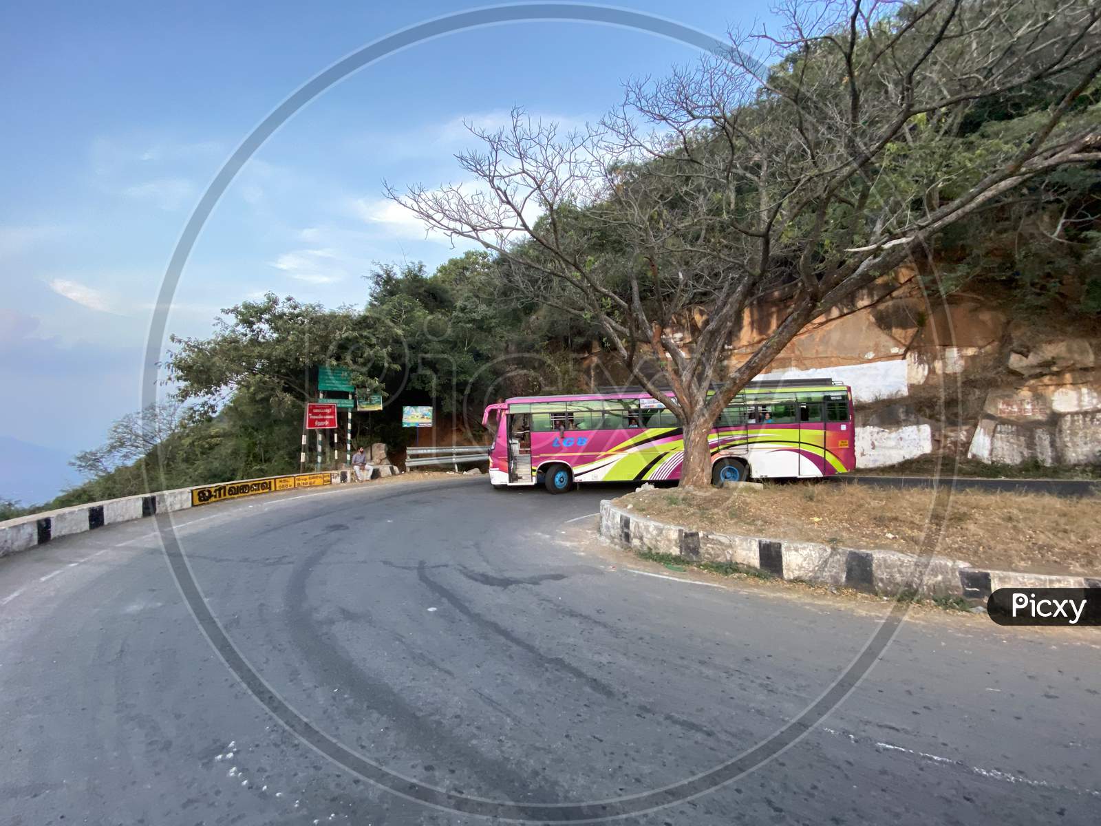 A Bus taking a turn along the ghat road at Hairpin Bend 