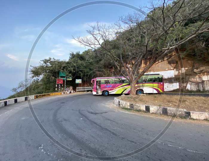 A Bus taking a turn along the ghat road at Hairpin Bend 