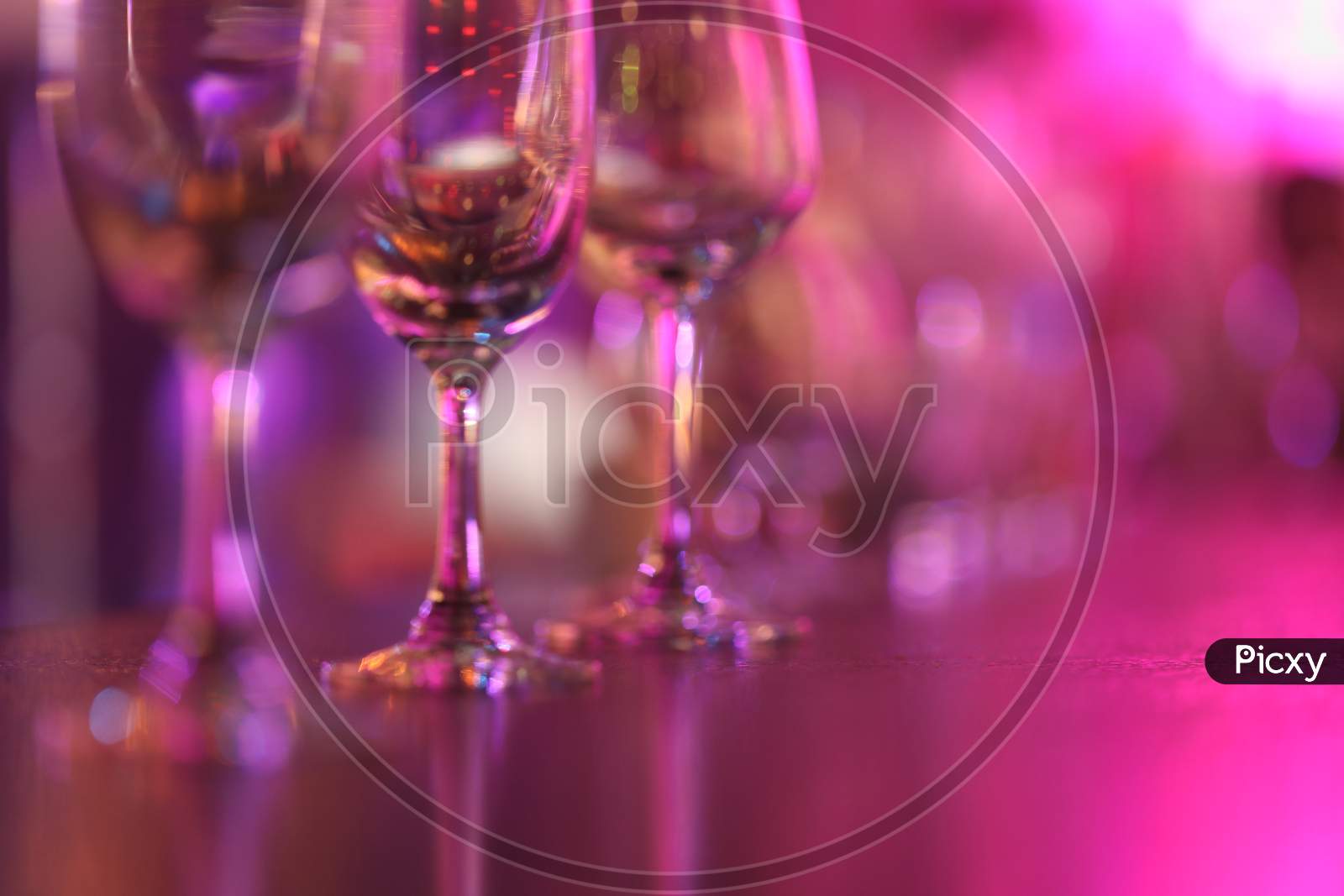 Wine Glasses In an Pub With Neon Lights Flare